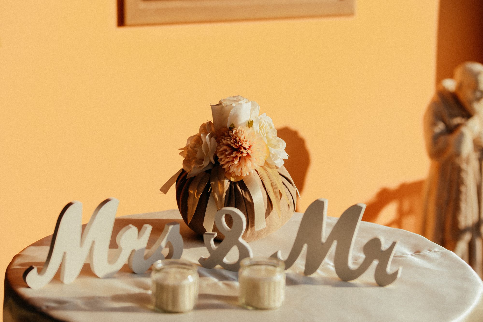 Mrs and Mr letters beside candles on a warm table